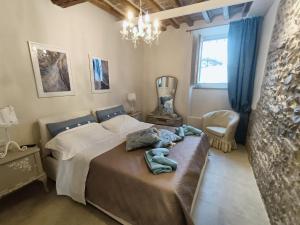 a bedroom with a bed and a chair and a window at AriediParma - Rooms&apartments in Parma