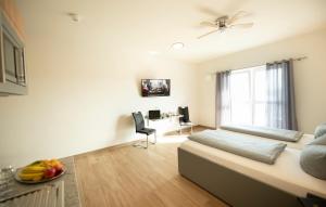 a bedroom with a bed and a table with a bowl of fruit at Stadthotel Donauwörth in Donauwörth