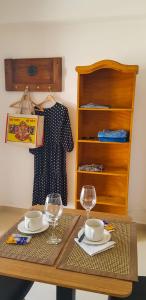 a wooden table with two plates and glasses on it at Apart del Centro 01 in Santa Fe