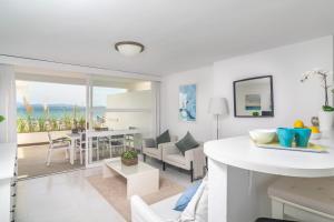 a living room and dining room with a view of the ocean at Ca'n Opus 321 in Port d'Alcudia