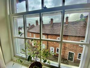 a window with a view of a brick building at Elegant Georgian Grade II Listed House full of charm - 3 Super king rooms - 3 Mins for Safari Park & Steam Train - Parking in Bewdley +21 photos