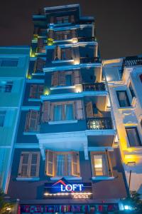 a tall building with a hotel sign on it at Taksim Loft Residence in Istanbul