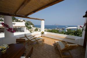 a balcony with a table and chairs and a view at Hotel Tesoriero in Panarea