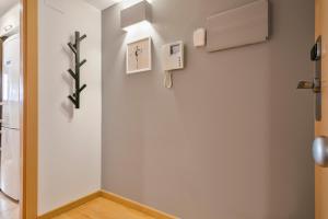 a hallway with a white wall with a cross on it at Inside Barcelona Apartments Princep in Barcelona