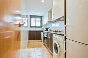 a kitchen with a washer and dryer in it at Inside Barcelona Apartments Princep in Barcelona