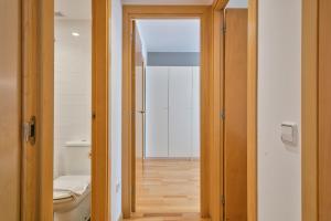 an open door to a bathroom with a toilet at Inside Barcelona Apartments Princep in Barcelona