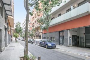 a street with cars parked on the side of a building at Inside Barcelona Apartments Princep in Barcelona