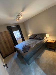 a bedroom with a large bed and a window at Town centre 3 bed luxury apartment in Wick