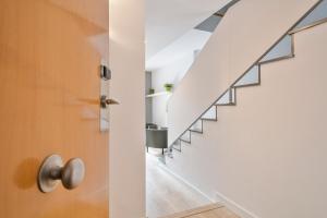 a staircase in a house with a door at Inside Barcelona Apartments Princep in Barcelona