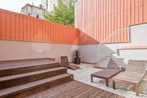 two chairs and a staircase on a building at Inside Barcelona Apartments Princep in Barcelona
