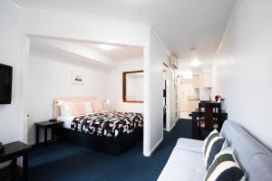 a hotel room with a bed and a couch at Arrow on Spencer in Melbourne +45 photos