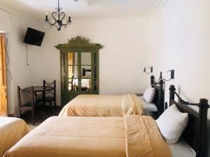 מיטה או מיטות בחדר ב-Hostal Qorichaska