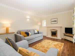 a living room with a couch and a fireplace at Oakdene in Stratford-upon-Avon