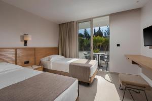 Postel nebo postele na pokoji v ubytování Platanista Hotel