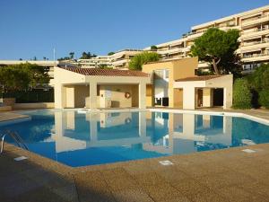 a large swimming pool in front of a building at Le Syrius in Nice