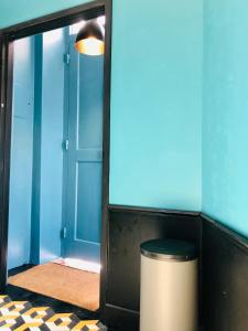 a hallway with a trash can and a mirror at Mouraria Deluxe Apartments in Lisbon