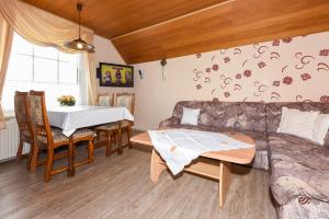 a living room with a couch and a table at Ferienwohnungen im Landhaus Oldenhof in Stedesdorf