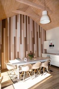 a dining room with a table and chairs at MĖLYNOJO KARPIO PIRTIES NAMAS in Kintai +5 photos