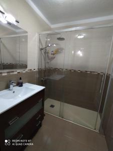 a bathroom with a glass shower and a sink at Villa in Parque Santiago 1 , sea View and all the Confort That you Need! in Playa de las Americas