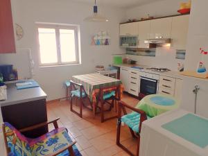 a kitchen with a table and chairs in it at Apartman Amarena in Starigrad-Paklenica