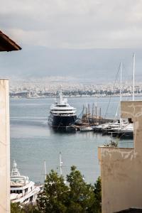 a large ship is docked in a harbor at Amazing apartment with view! in Piraeus