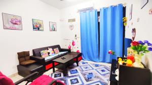 a living room with a couch and a table at Mevin Woodsbury Home Butterworth Penang in Butterworth