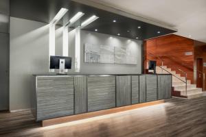 a lobby with a television and a staircase at AC Hotel Badajoz by Marriott in Badajoz