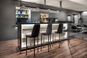 a bar with black stools in a kitchen at AC Hotel Badajoz by Marriott in Badajoz