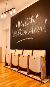 a classroom with chairs and a chalkboard on the wall at Edle Ferienwohnung - Industrial Style in Dresden