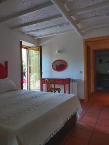 a bedroom with a bed and a table and a window at Quinta do Rio in Vale do Serrão