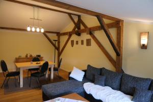 a living room with a couch and a table at Ferienwohnung Weideglück in Osten
