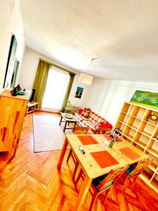 a living room with a table and a couch at Green Apartman in Eger