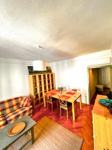 a living room with a table and a couch at Green Apartman in Eger