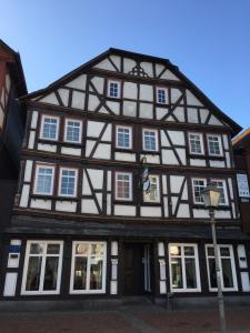 an old black and white building with white windows at Haus Oberscholtes in Grünberg