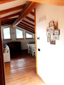 a living room with wood floors and a dining room at Casa Leonilla in Pellizzano