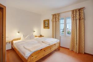 a bedroom with a large bed and a window at Seeberg - Haus Annamirl in Bayrischzell