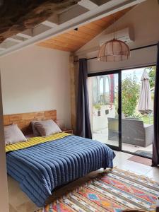 a bedroom with a bed and a large window at 299 Bigaroux in Saint-Émilion