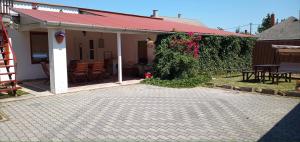 a house with a red roof and a patio at Emma vendégház in Sárospatak