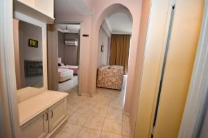 a hallway with a bathroom with a mirror and a bedroom at Pasahan Apartments in Marmaris