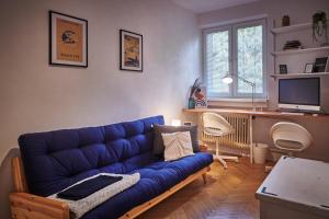 a living room with a blue couch and a television at Hidden Gem of Jasna, Váš skrytý poklad v Jasnej in Liptovský Mikuláš