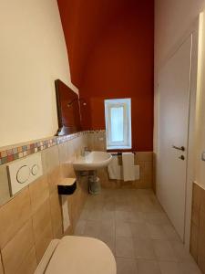 a bathroom with a toilet and a sink at L'Armonia in Gaeta
