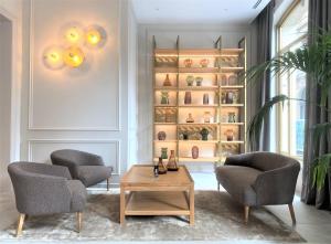 a living room with two chairs and a coffee table at Colón Hotel Barcelona in Barcelona