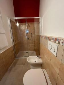 a bathroom with a shower and a toilet and a sink at L'Armonia in Gaeta
