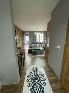 a living room with a couch and a rug on the floor at Apartamentylove - Apartament u Janicka, 100m do Krupówek in Zakopane