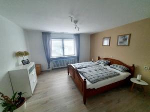 a bedroom with a large bed and a window at Ferienwohnung Baumann in Neupotz