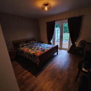 a bedroom with a bed and a sliding glass door at Wood Rising in Newark-on-Trent