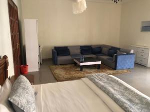 a living room with a couch and a coffee table at Hotel Le Littoral Des Almadies in Dakar