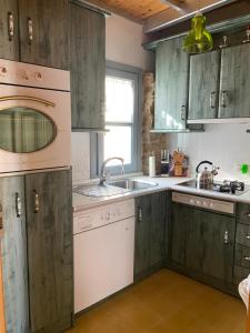 a kitchen with green cabinets and a sink at Casa del torno de las monjas in Úbeda +31 photos