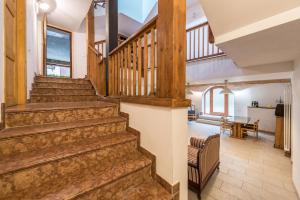 a staircase in a house with a living room and a dining room at Agriturismo Al Gallo Nero Giallo in Tenno