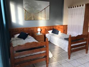 a bedroom with two beds and a bridge on the wall at Glynns at Club Correze in Meymac